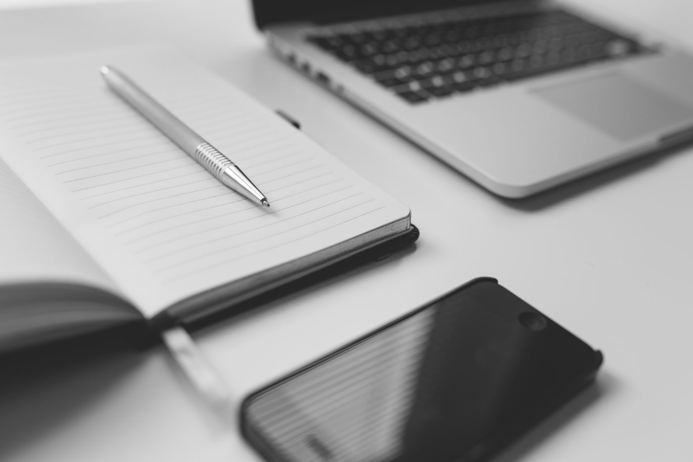 Desk with computer, phone, pen and paper