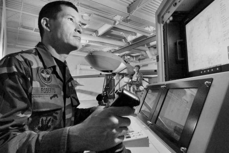 Military Instructor looking into a screen