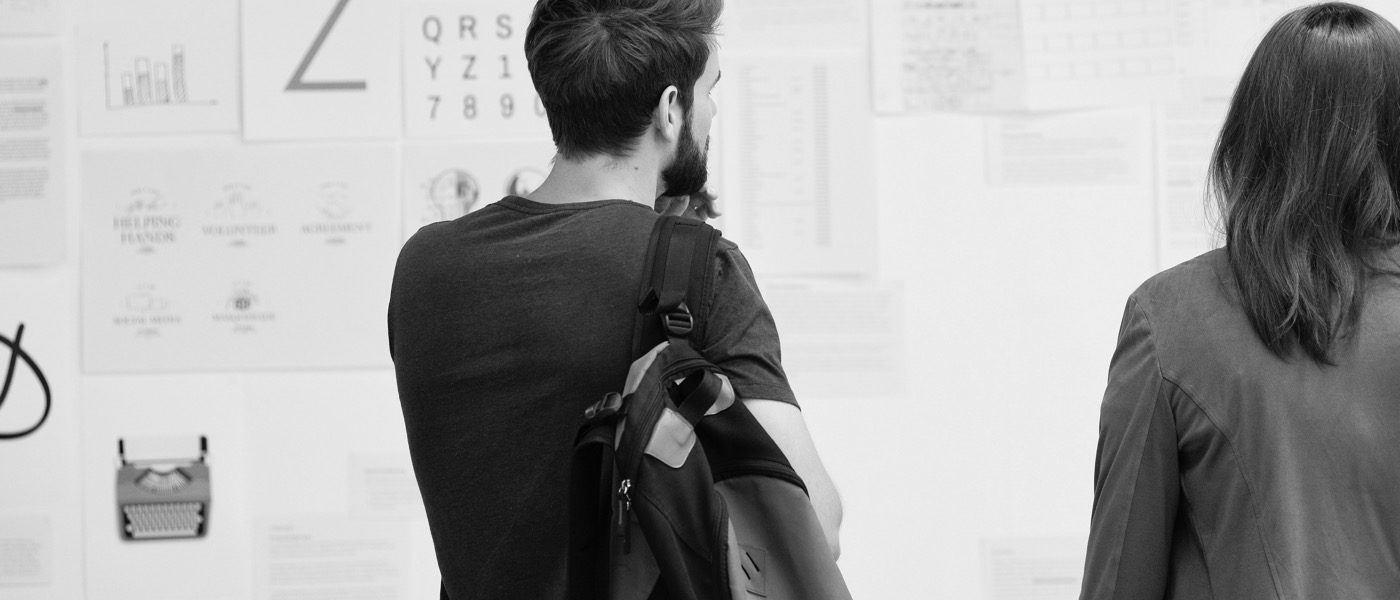 Students Reviewing Schedule on Bulletin Board