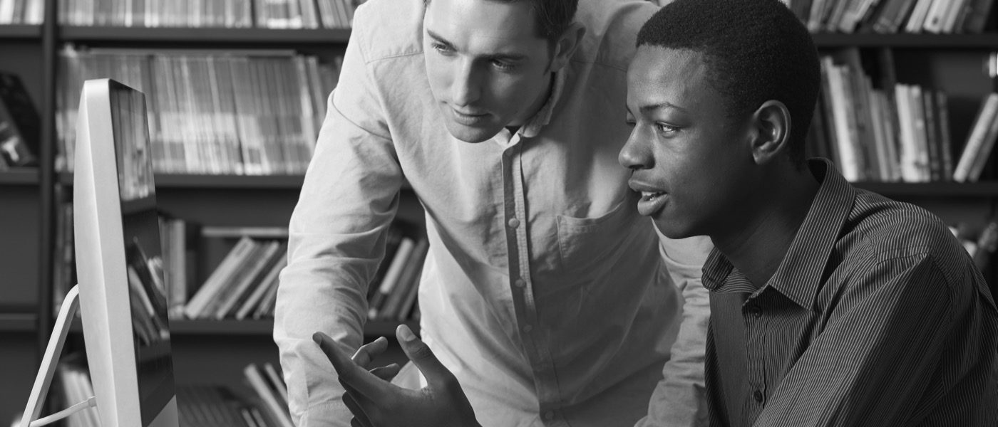 Two Students Viewing Computer Monitor