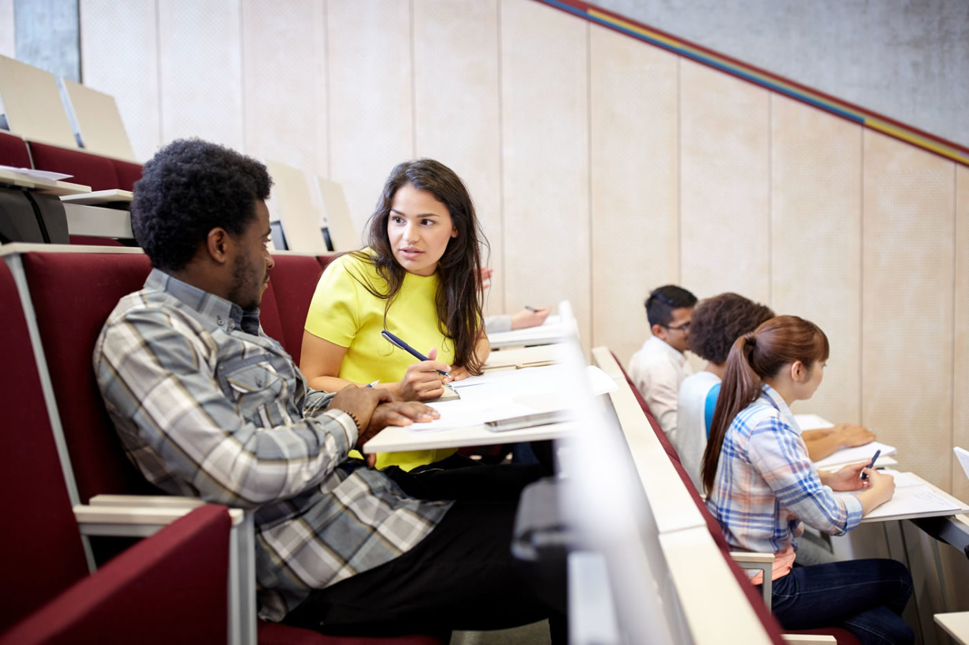 Students discussing topics in lecture hall