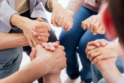 People Holding Hands For Encouragement