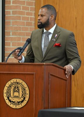 Al Lampkins stands and speaks at a podium.