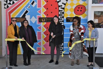 Britney Deveault cuts the ribbon in front of the Success Closet.