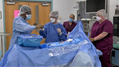 Surgical Tech students work in a simulated operating room lab.