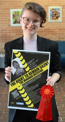 Cheyenne Puckett displays her poster with a red 2nd place ribbon.