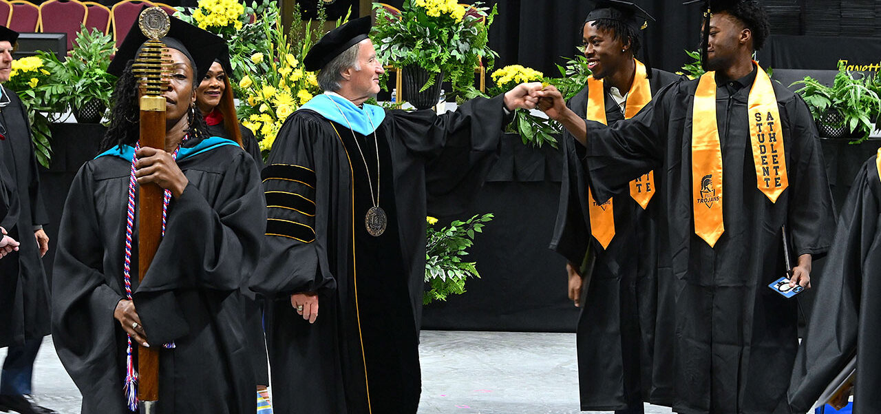 Dr. Sorrells Hi 5 With the Graduates