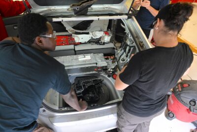 Students work on a hybrid vehicle.