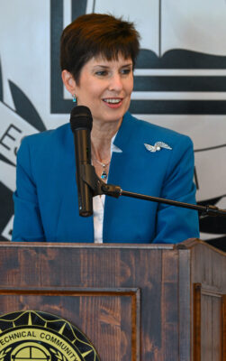 Teena Piccione speaks into a microphone