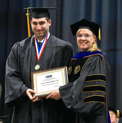 Graduate-Troy-Louis-Hobbs-III-is-presented-with-the-NC-Community-Colleges-Academic-Excellence-Award-by-Dr.-Murtis-Worth