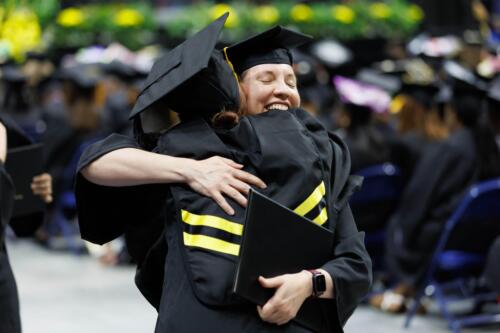 Two-graduates-hug-in-celebration