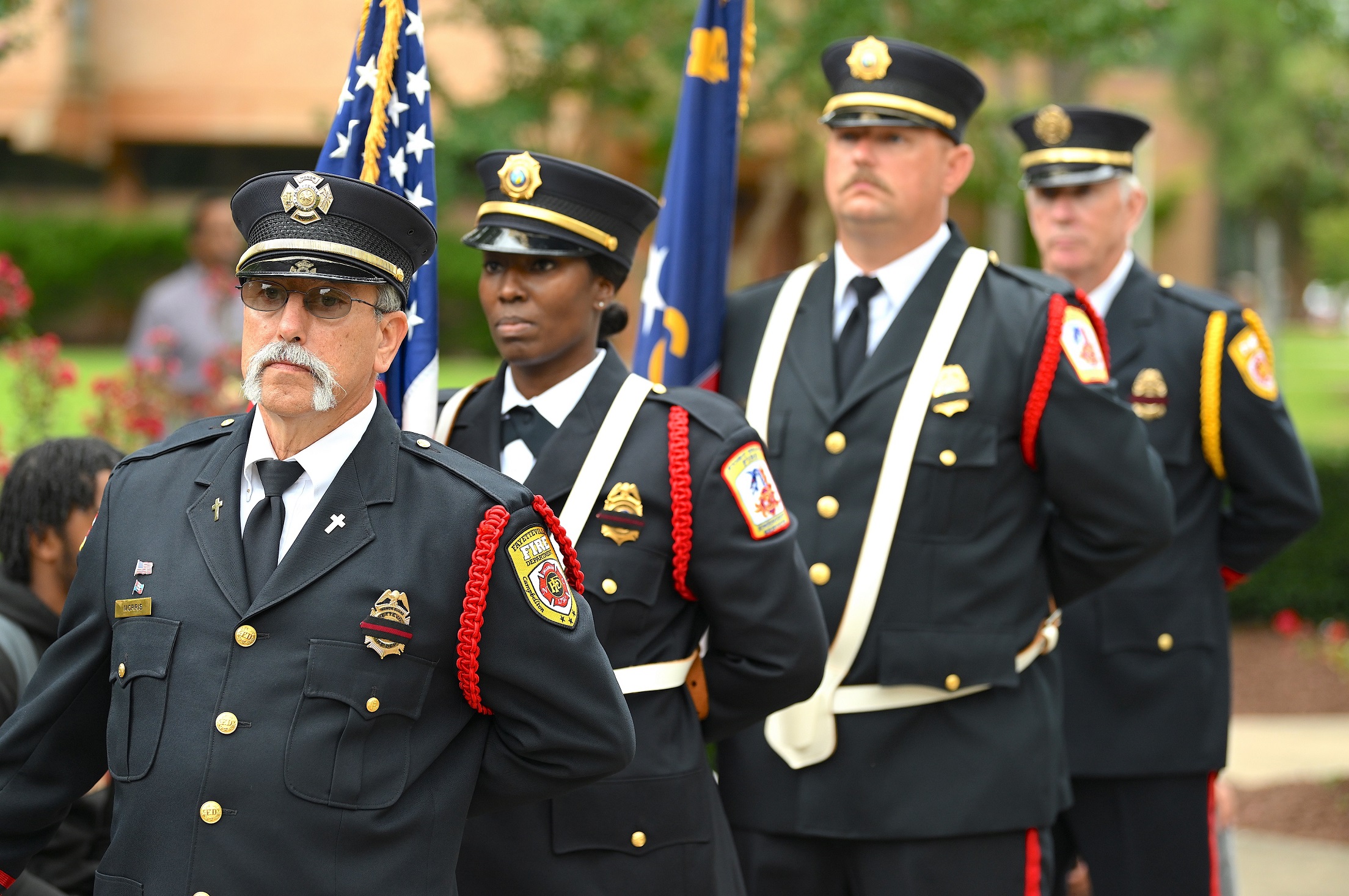 Members of the Cumberland County Emergency Services Honor Guard walk in a line to post the colors.