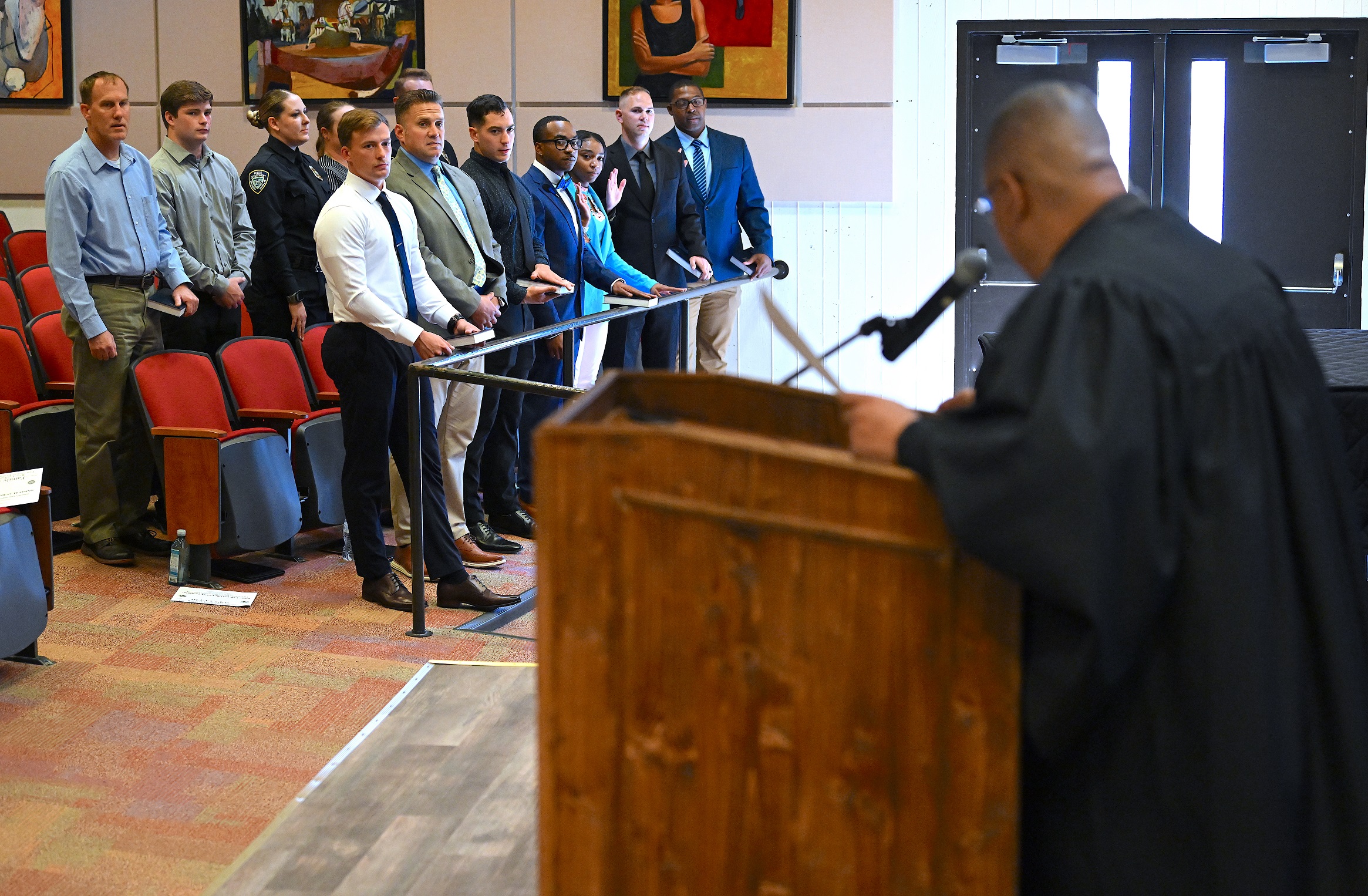 The BLET graduates stand as they prepare to take the oath at graduation.