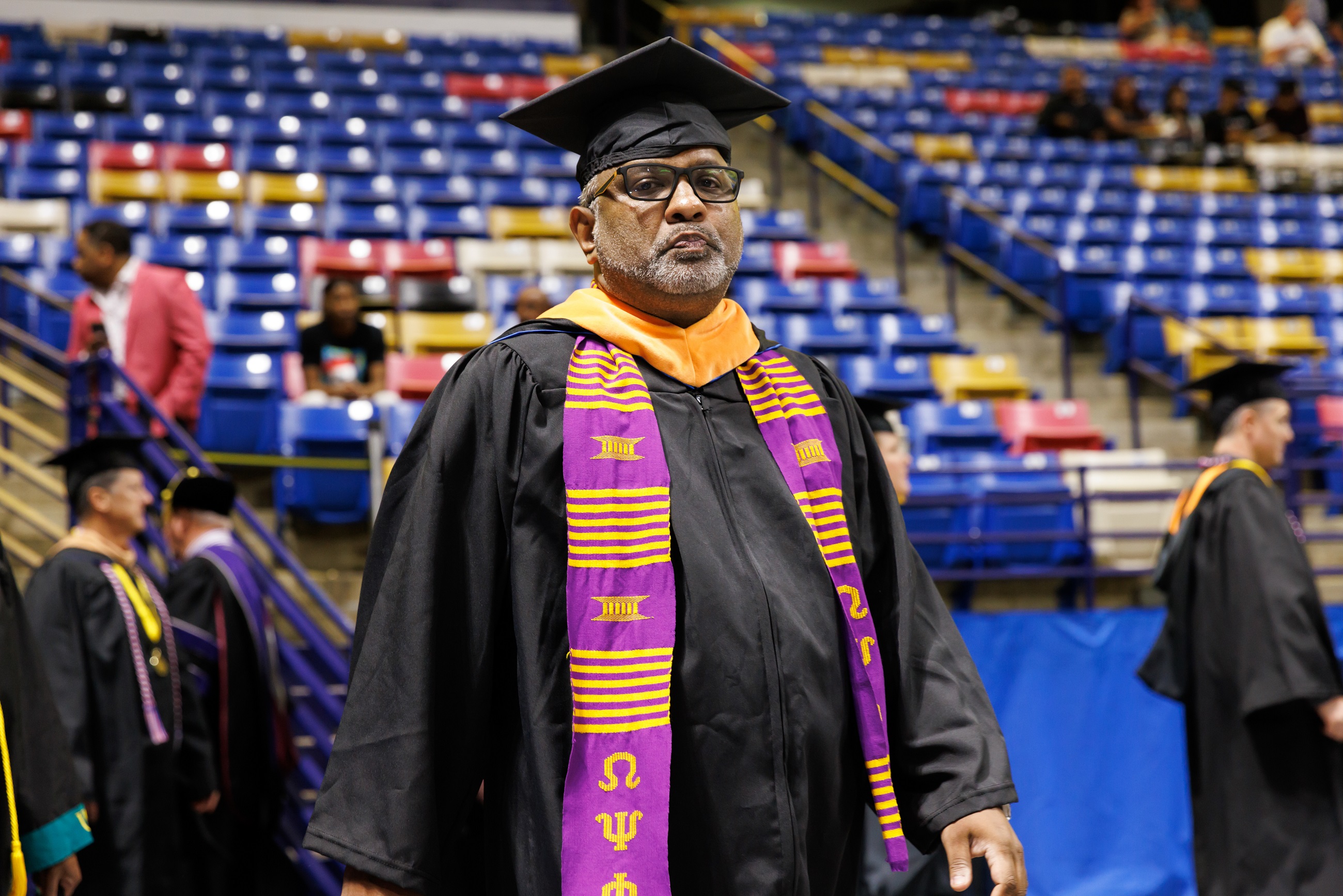 A faculty member walks into the Crown.