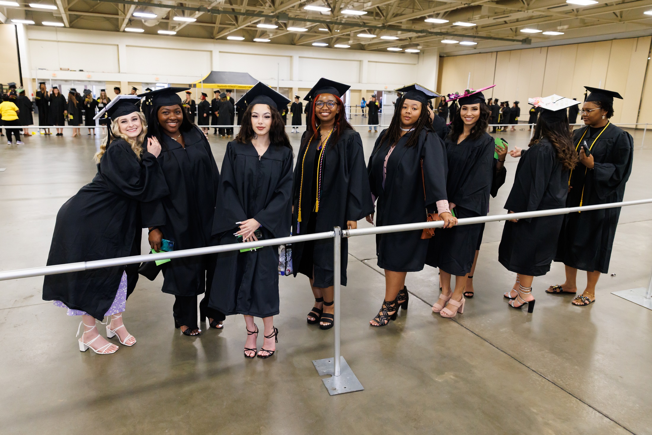 Graduates wait in line in the staging area in the Crown Expo Center.