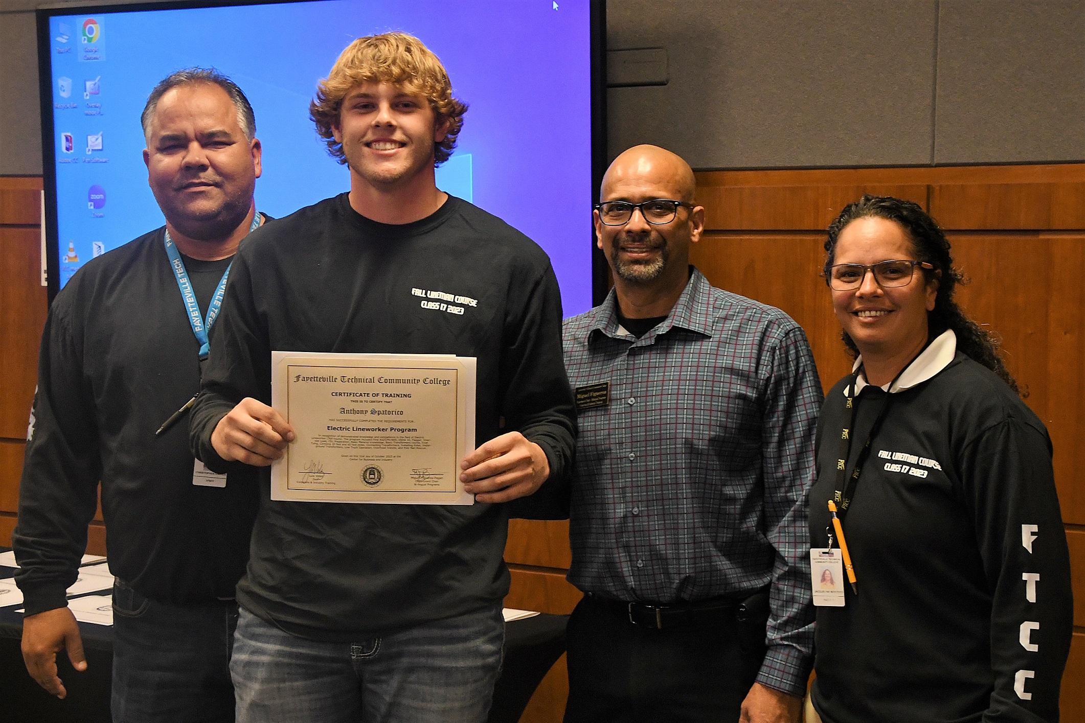 A graduate of FTCC's Electric Lineworker Basic Training course poses after receiving his certificate.