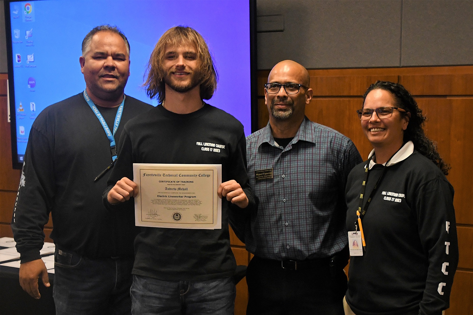 A graduate of FTCC's Electric Lineworker Basic Training course poses after receiving his certificate.