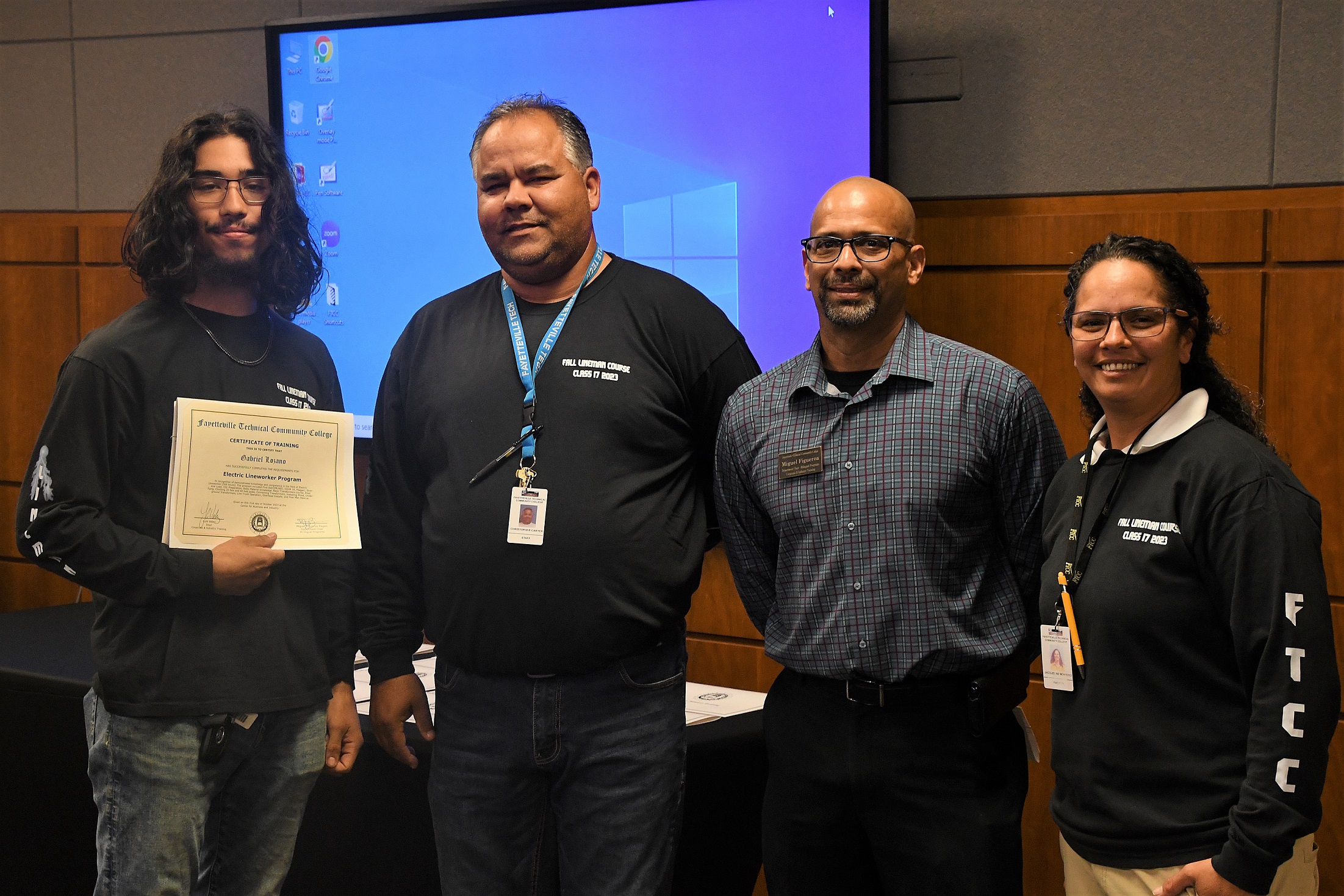 A graduate of FTCC's Electric Lineworker Basic Training course poses after receiving his certificate.