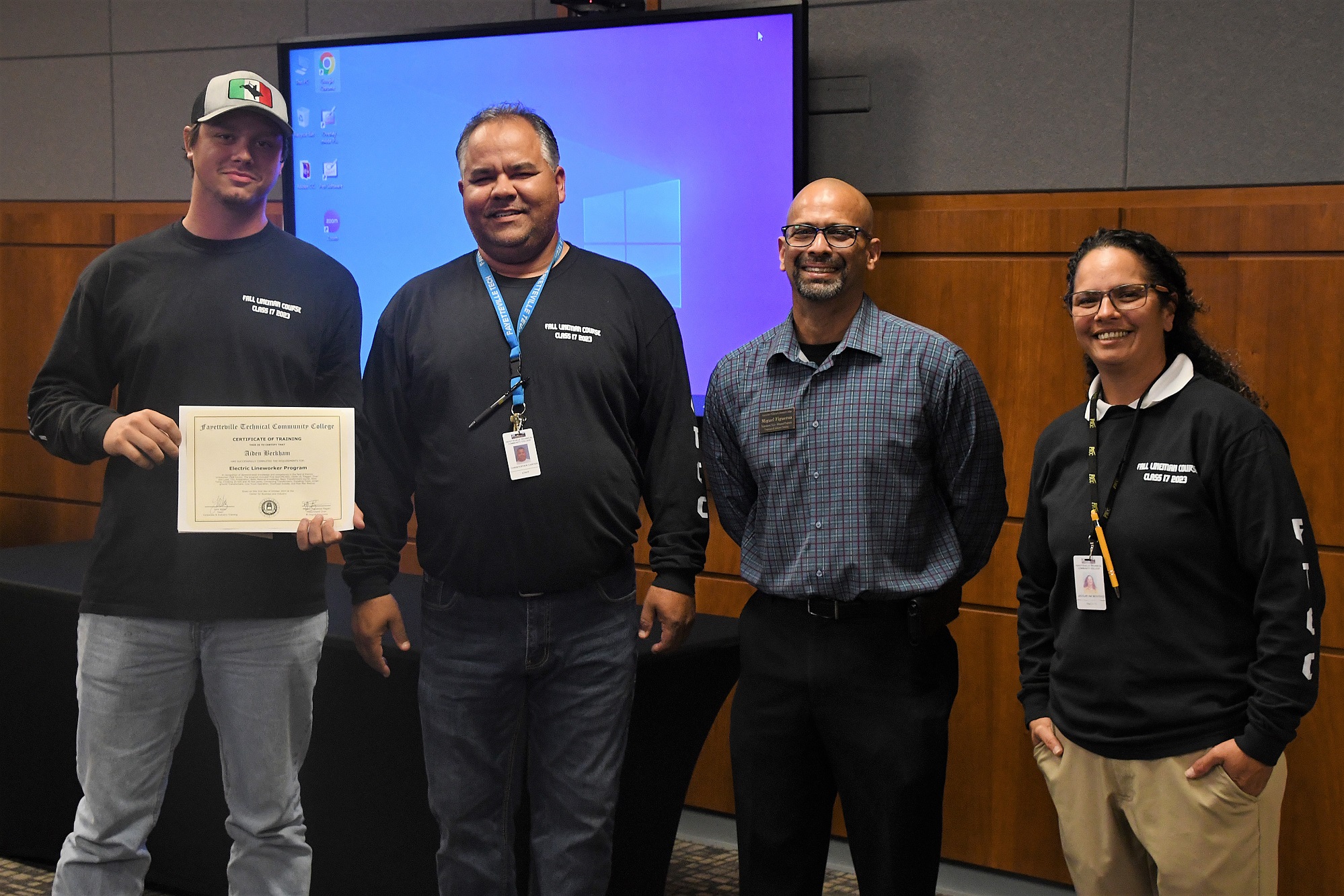 A graduate of FTCC's Electric Lineworker Basic Training course poses after receiving his certificate.