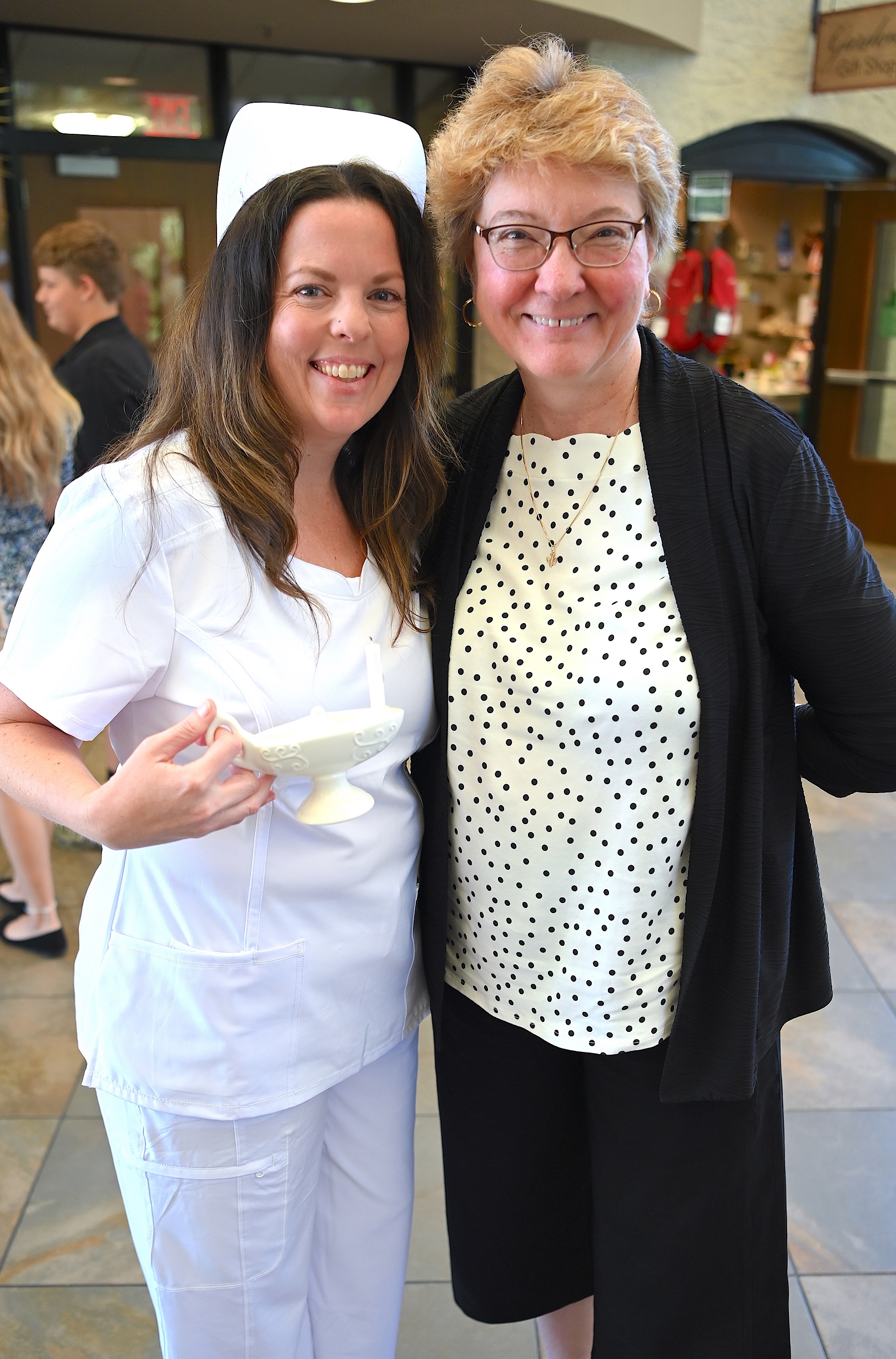 A nursing graduate poses for a photo with FTCC Vice President of Student Services Dr. Rosemary Kelly.