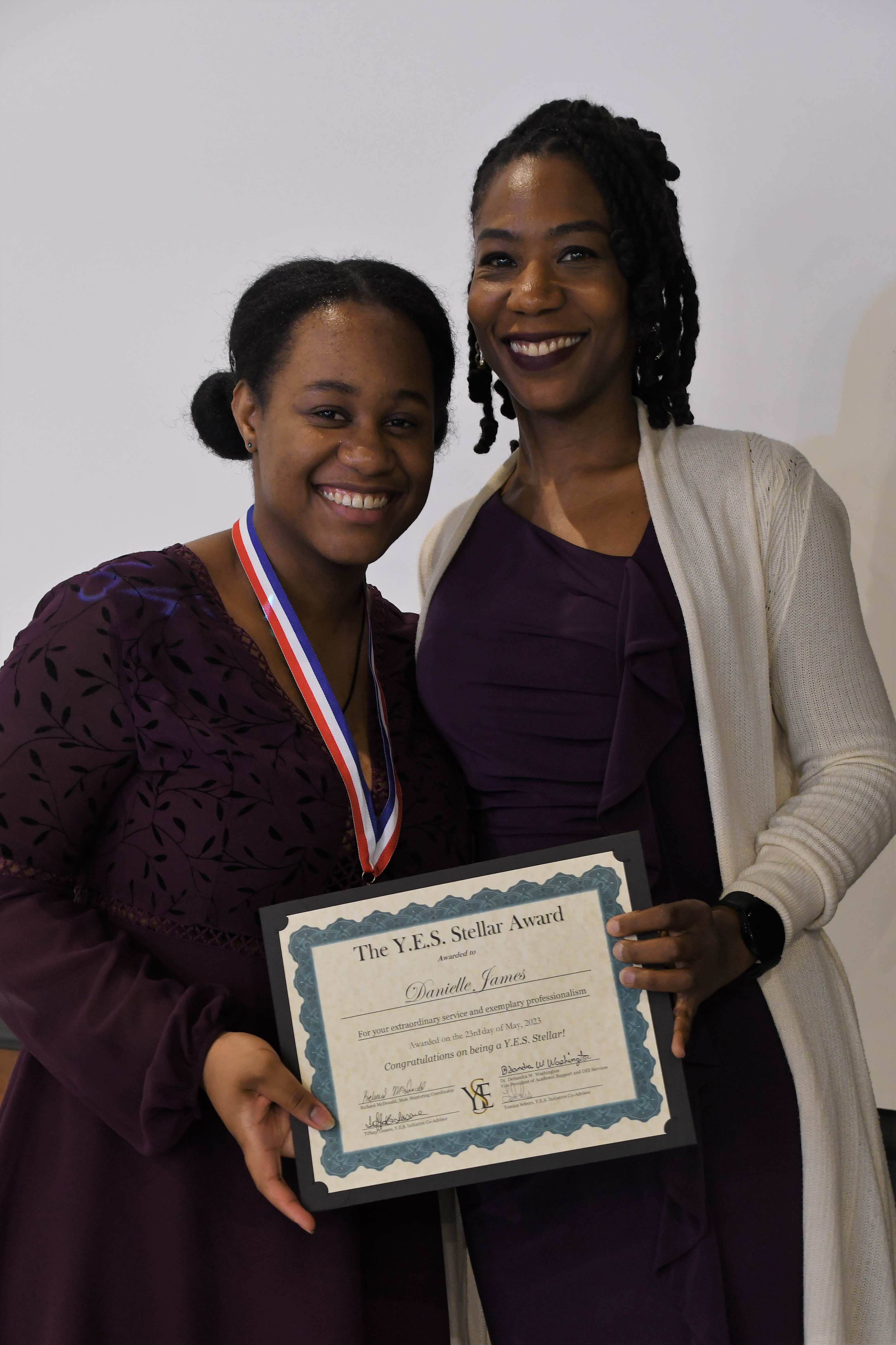 A student receives a YES Stellar Award.