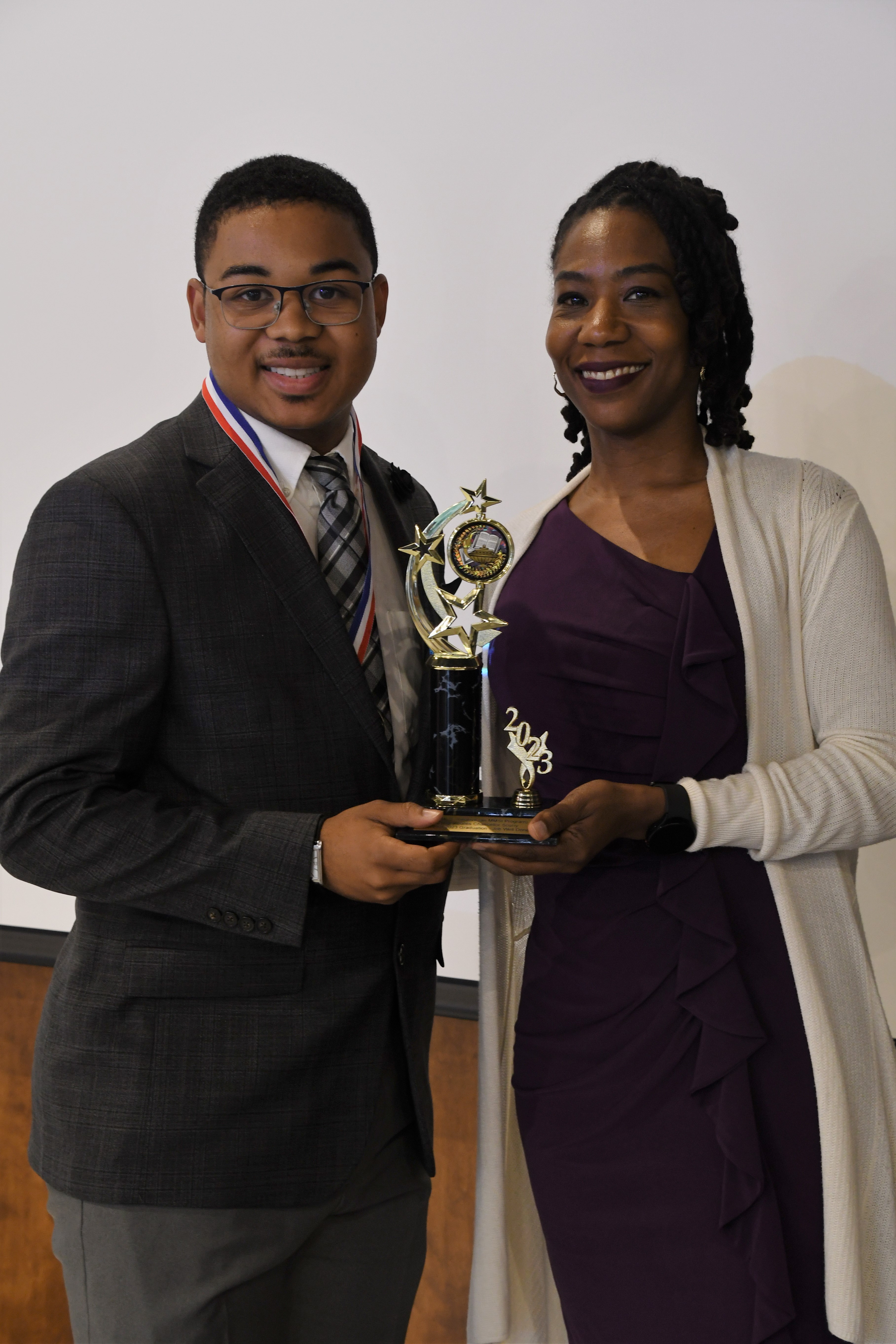 A student receives a trophy of special recognition.